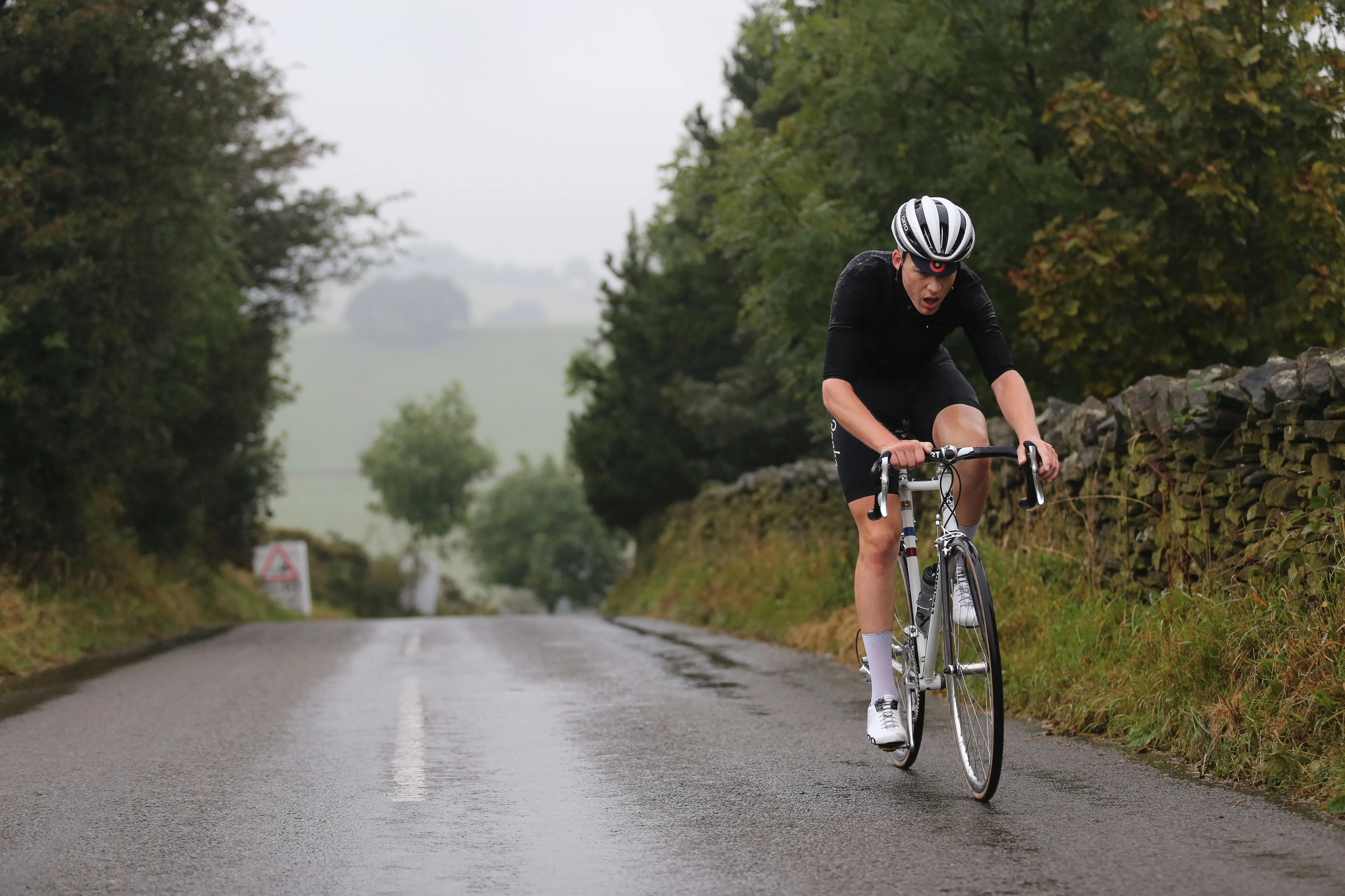 Cyclist riding solo in wet conditions during Manchester to London endurance ride