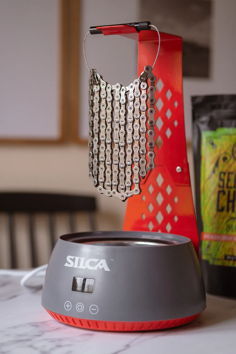 SILCA chain waxing system with bike chain suspended above hot melt wax pot